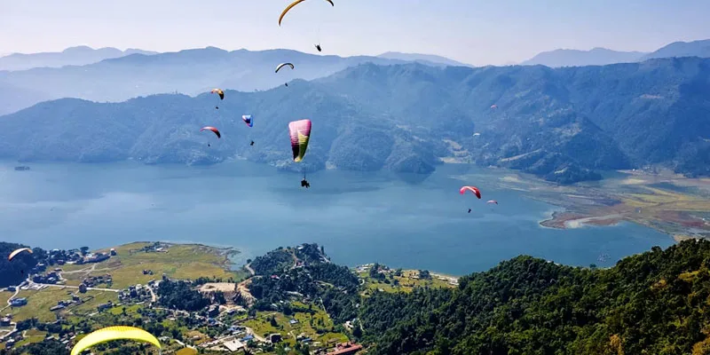 paragliders at phewa lake